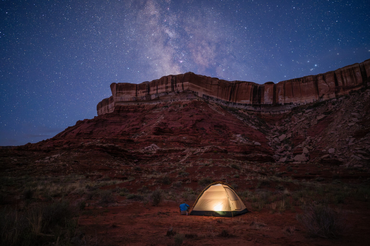 A tent under the stars during an OARS wilderness whitewater rafting trip.