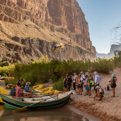 Helicopter leaves after dropping off OARS guests in Whitmore Wash for a rafting trip down the lower Grand Canyon