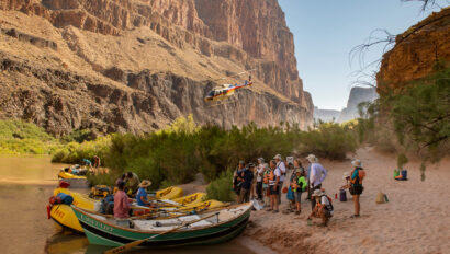 Helicopter leaves after dropping off OARS guests in Whitmore Wash for a rafting trip down the lower Grand Canyon