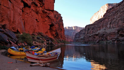 OARS raft and dory moored on a sandy beach in the late afternoon in Grand Canyon