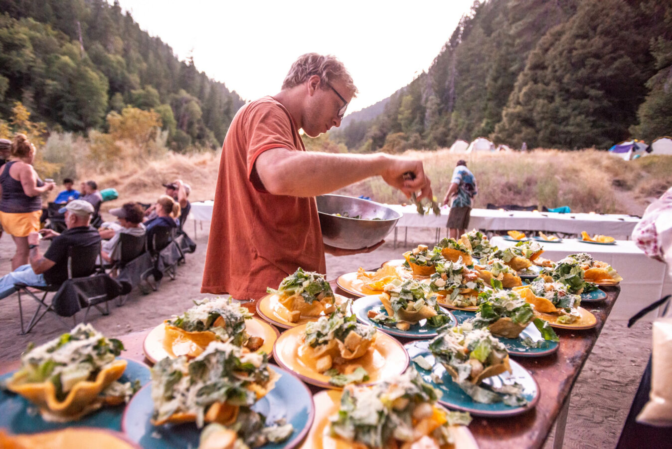 Guide preparing a gourmet meal for guests on the Rogue River.