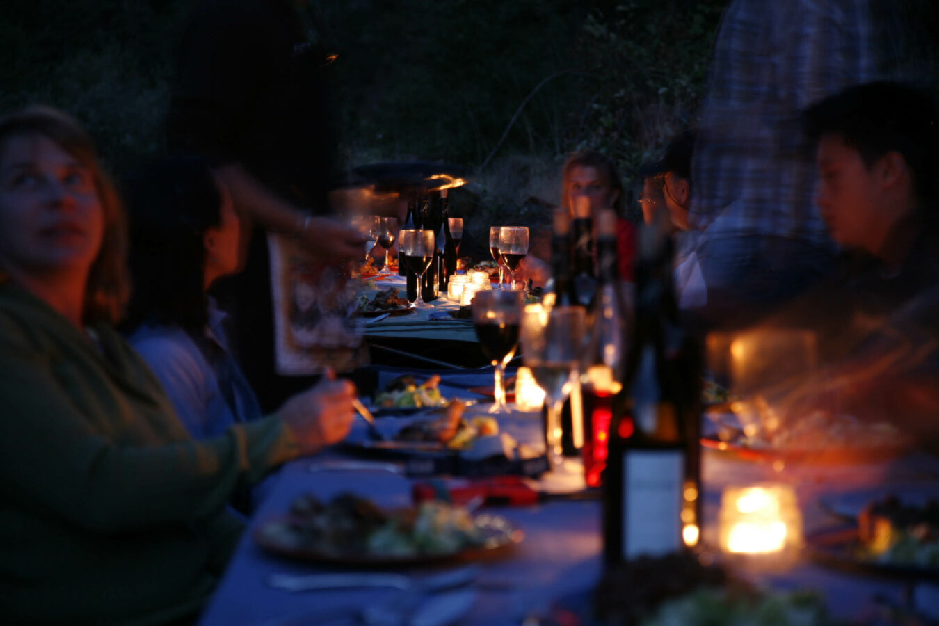 Guests eating by candle light on the Rogue River.