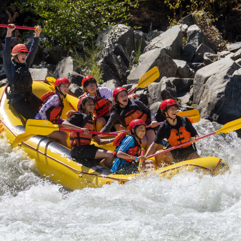 An OARS guide leads a high school group through whitewater rapids on the South Fork of the American River in California.