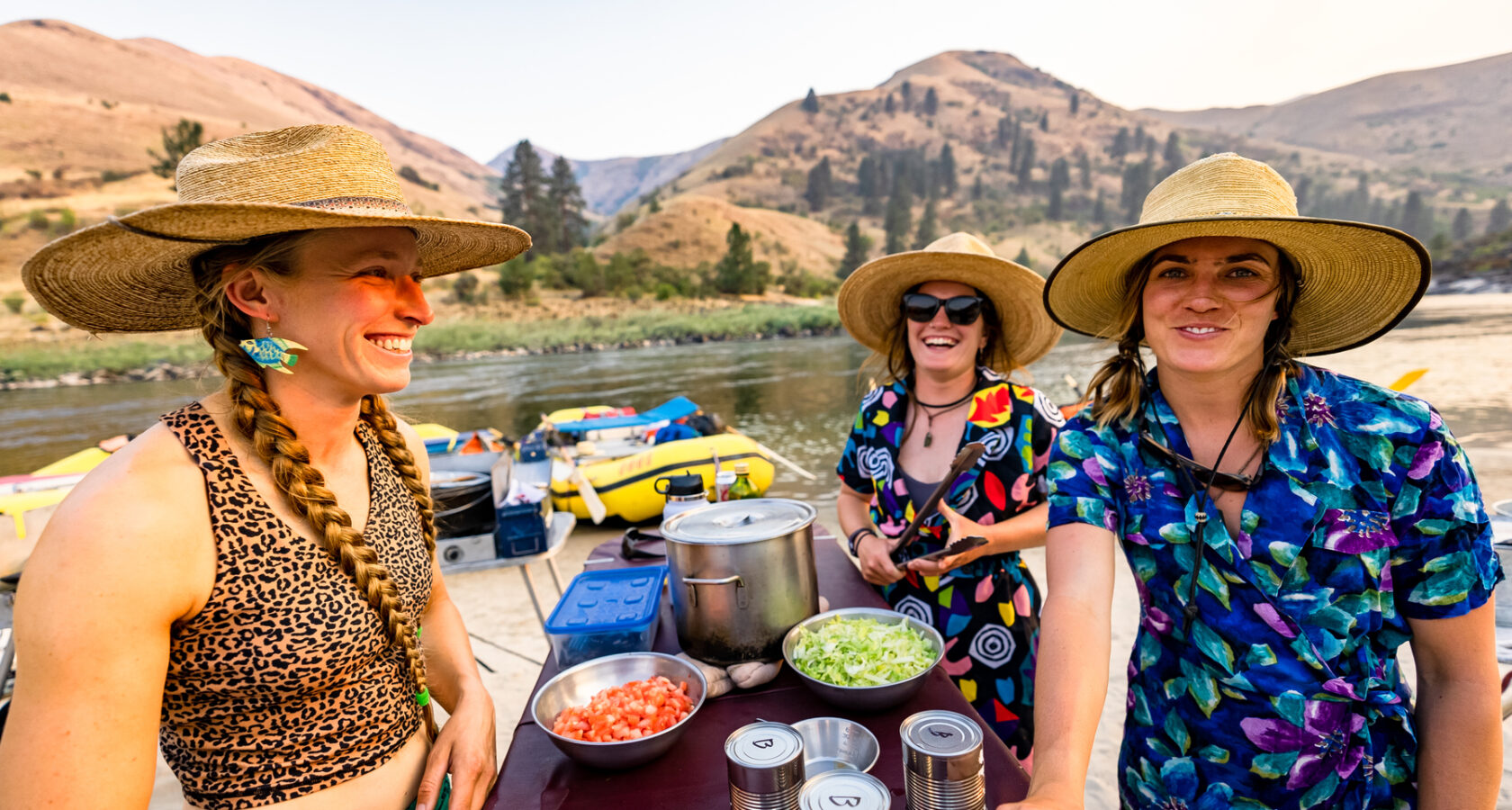 Three female river guides in big hats with big smiles