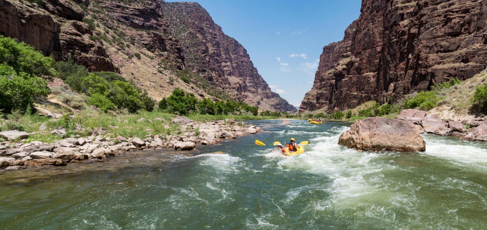Inflatable kayakers maneuver through a rapid on the Green River through Gates of Lodore.