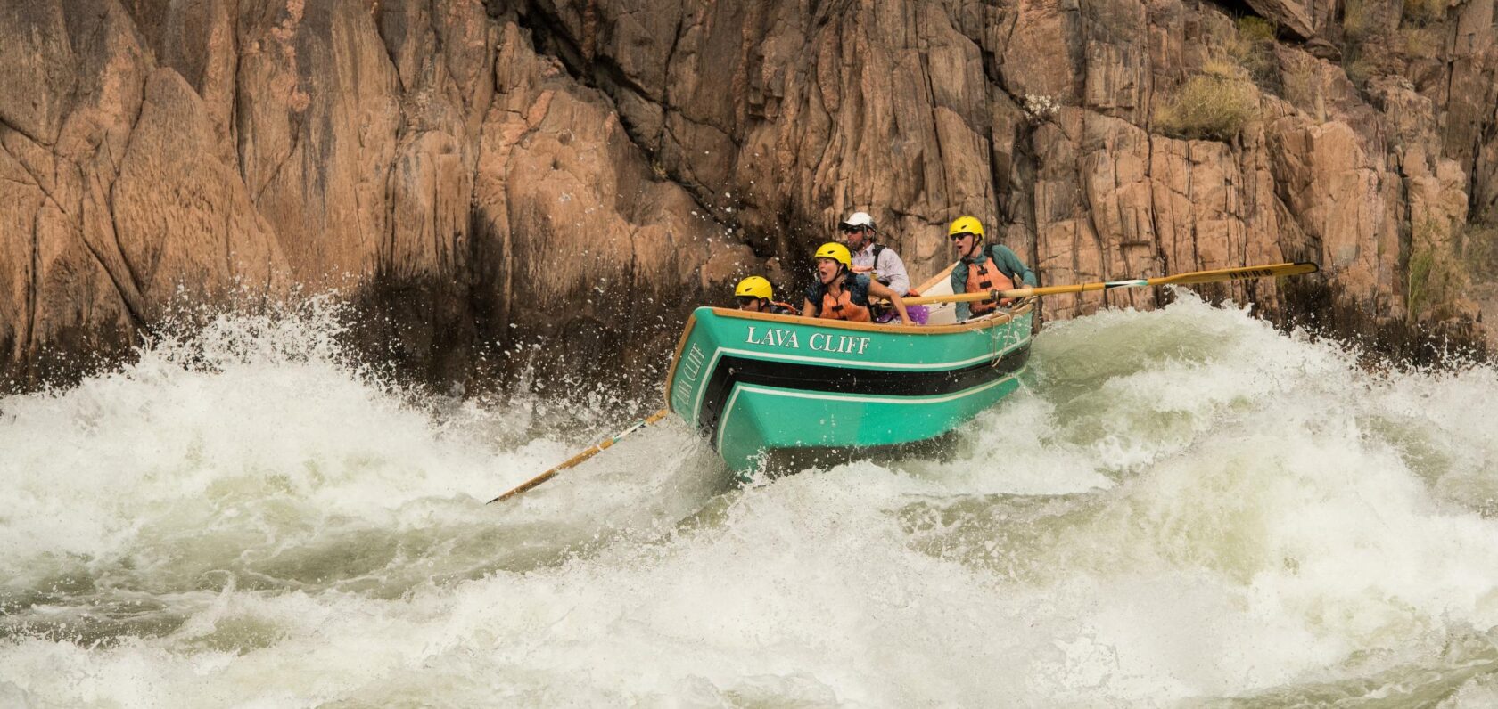 Passengers in a dory make it through a rapid on the Colorado River through Grand Canyon.