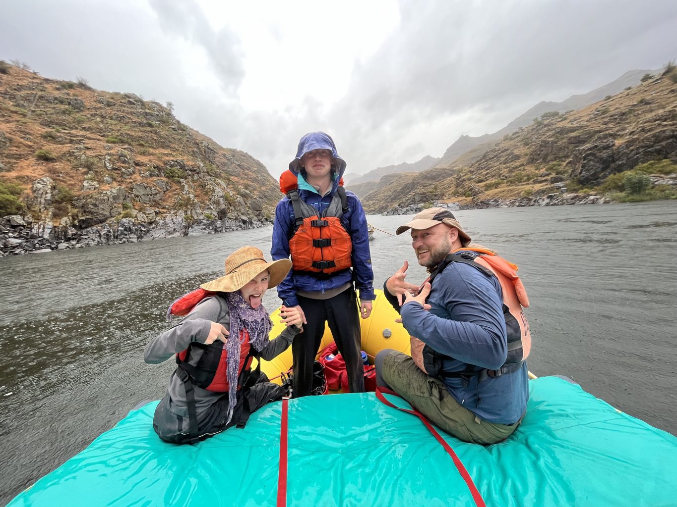 A family goofs around on a drizzly day on the Snake River