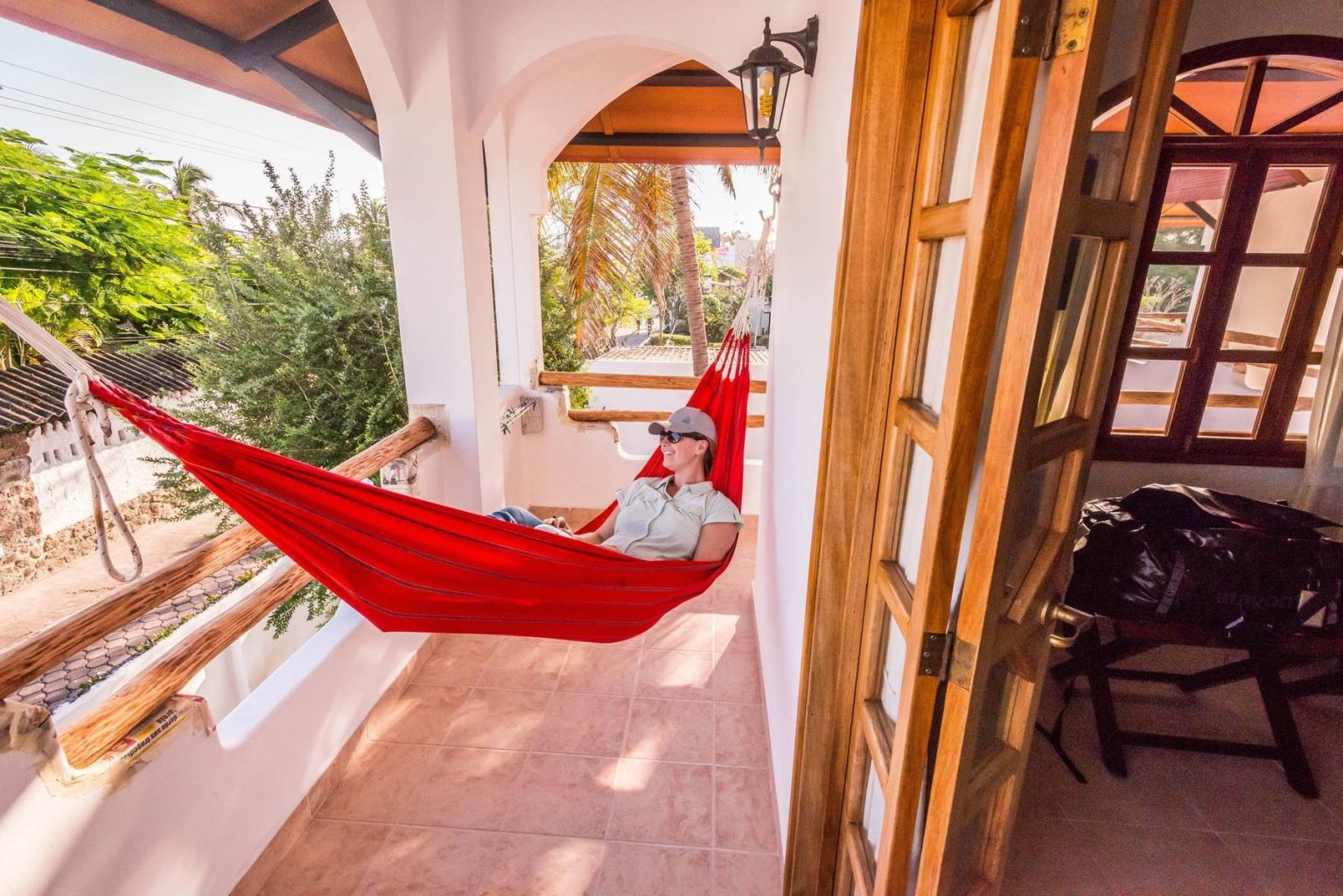 A traveler takes a breakin a hammock while visiting Galapagos