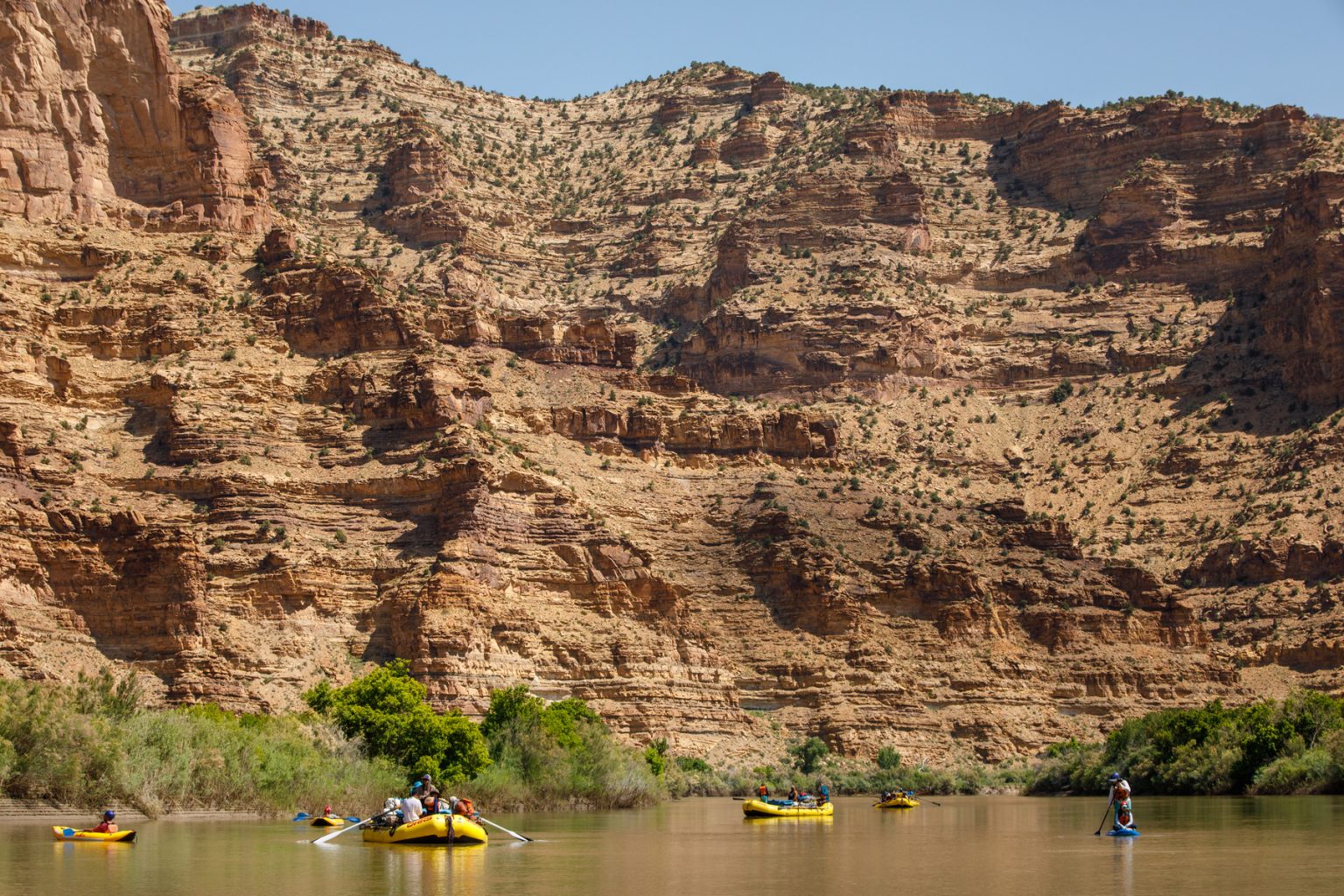 Floating through Desolation Canyon on a standup paddle board, inflatable kayak and raft